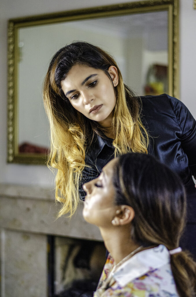 Makeup Artist doing makeup on a client