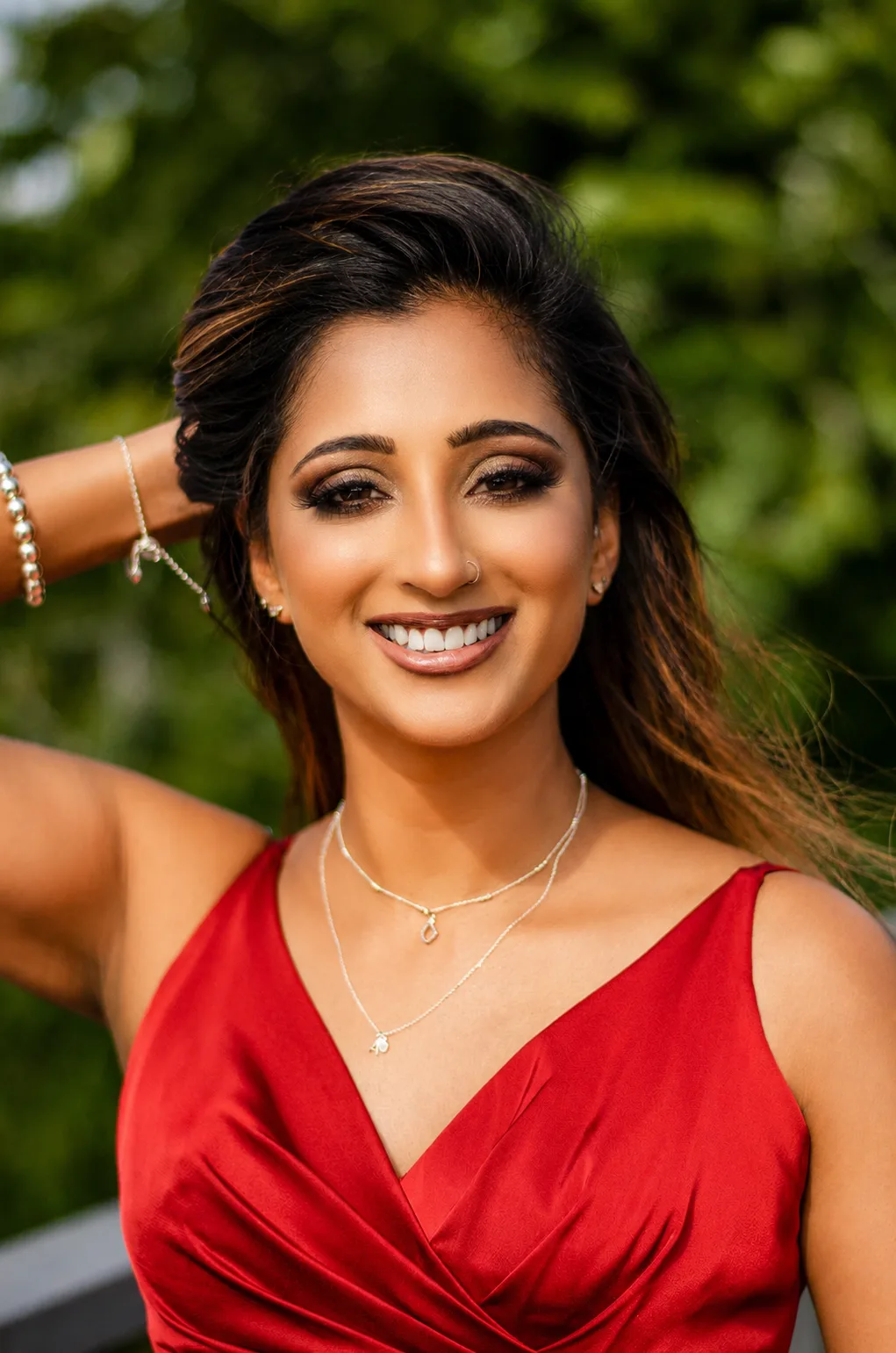 Full face bridal makeup outdoors - warm smoky eye, bold lip and red satin dress by MZ Makeup