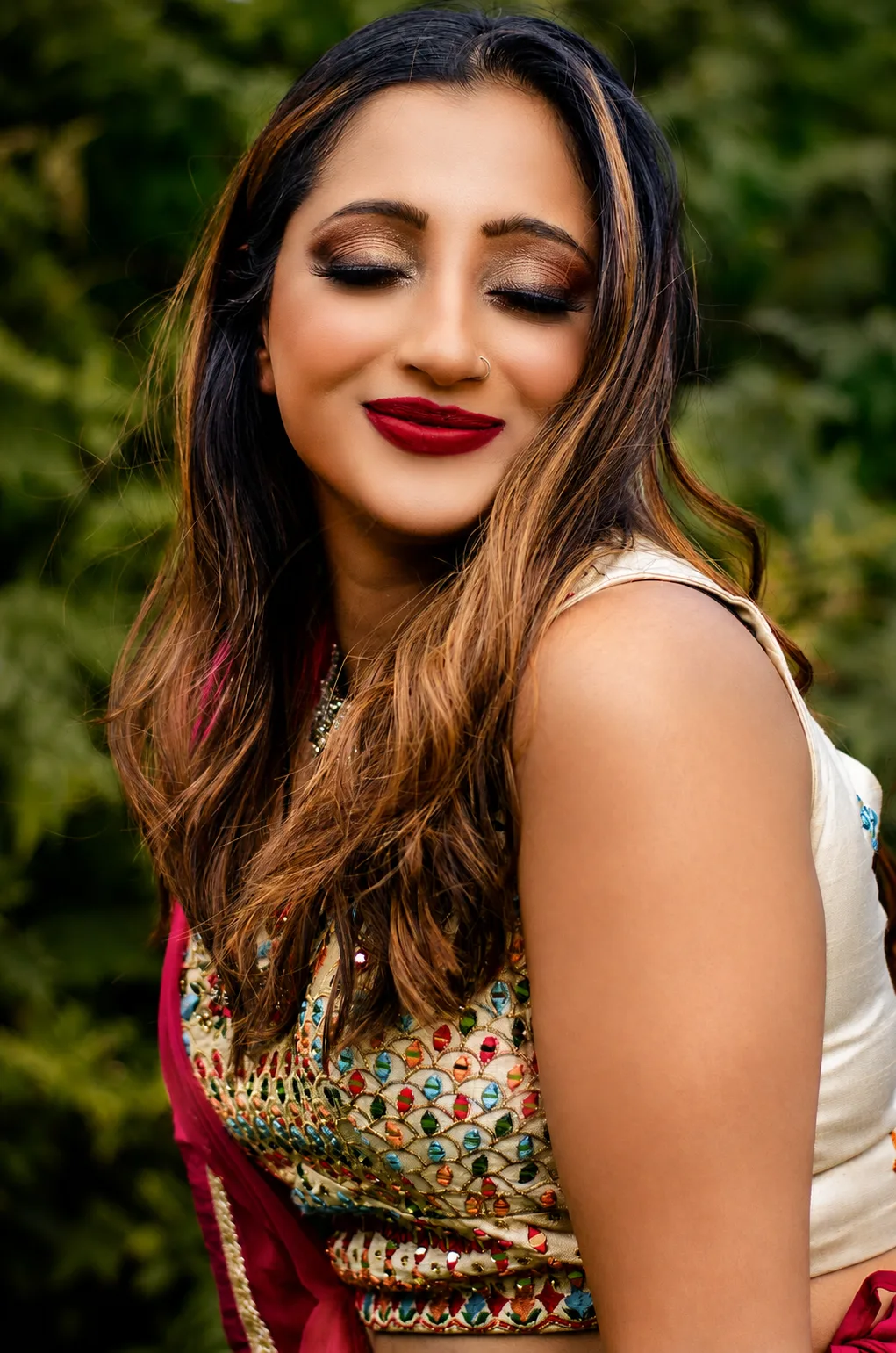 Indian bridal makeup eyes closed - warm copper smoky eye, cherry-red lip and traditional embroidered outfit by MZ Makeup