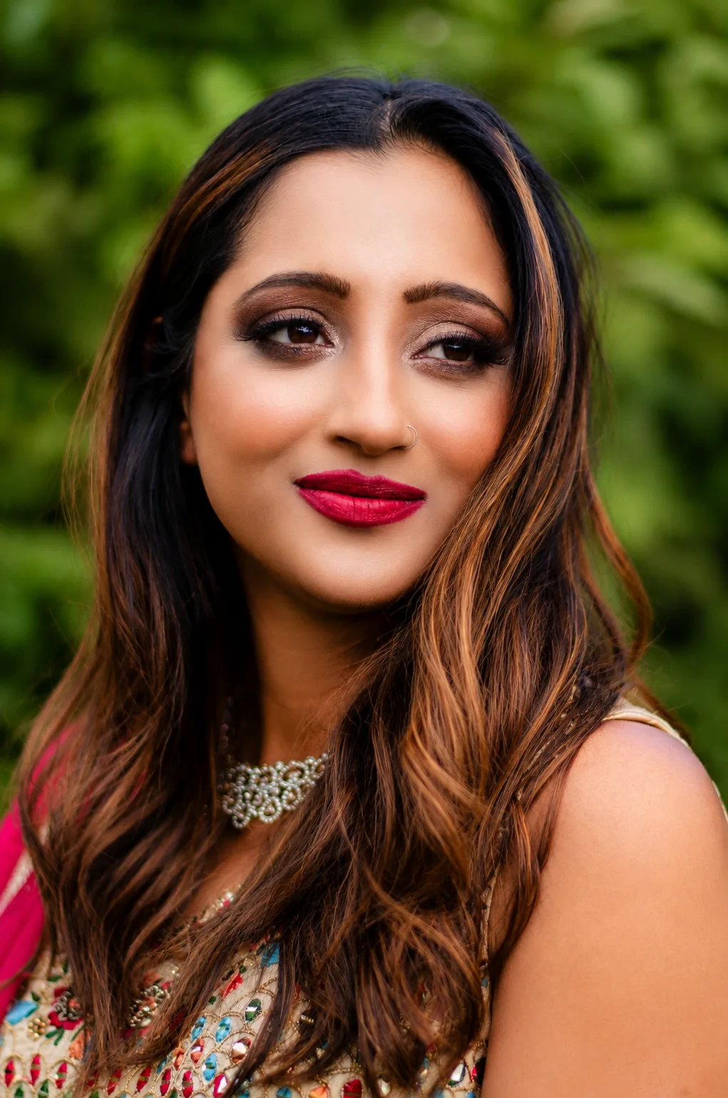 Indian bridal makeup full face - bold red lip, warm smoky eye and beaming smile by MZ Makeup