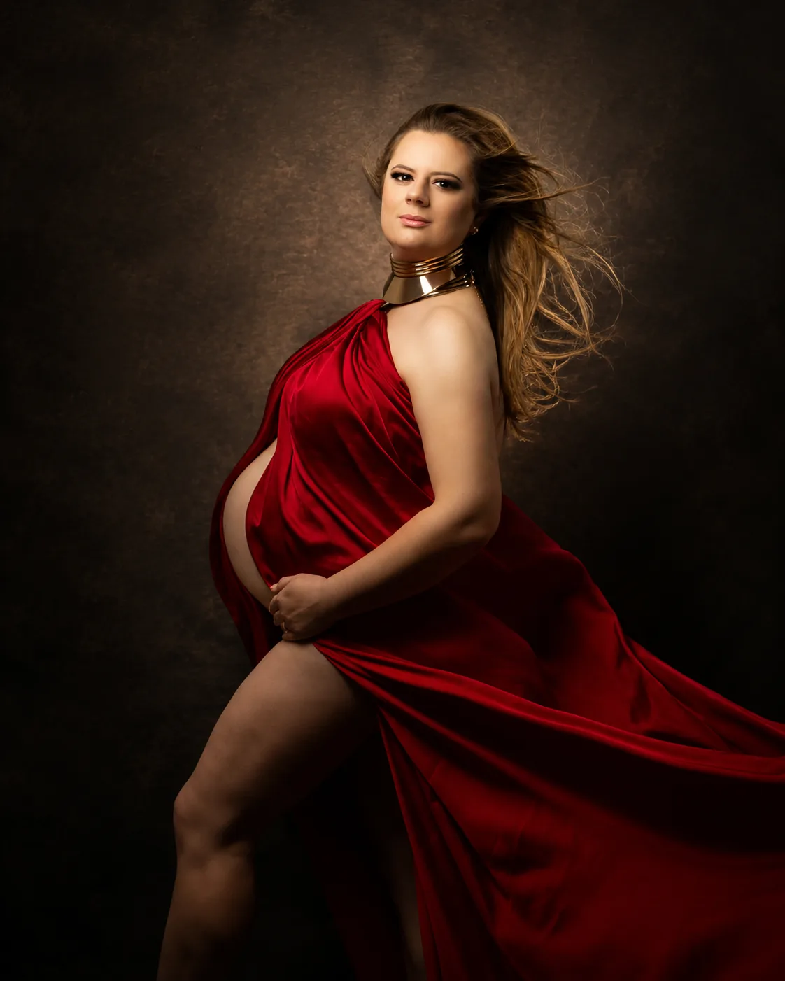 Maternity photoshoot makeup - bronzed glowing skin, red silk gown and gold collar necklace by MZ Makeup