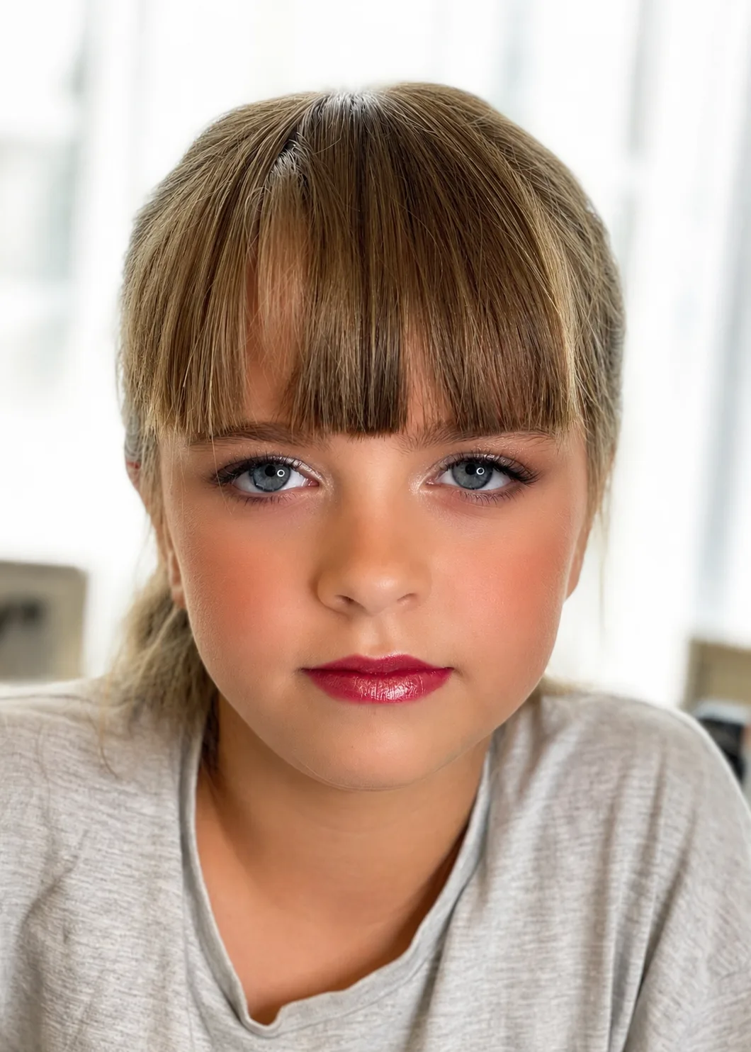 Children's party makeup - soft blue eye, warm blush and berry-red lip on young girl by MZ Makeup