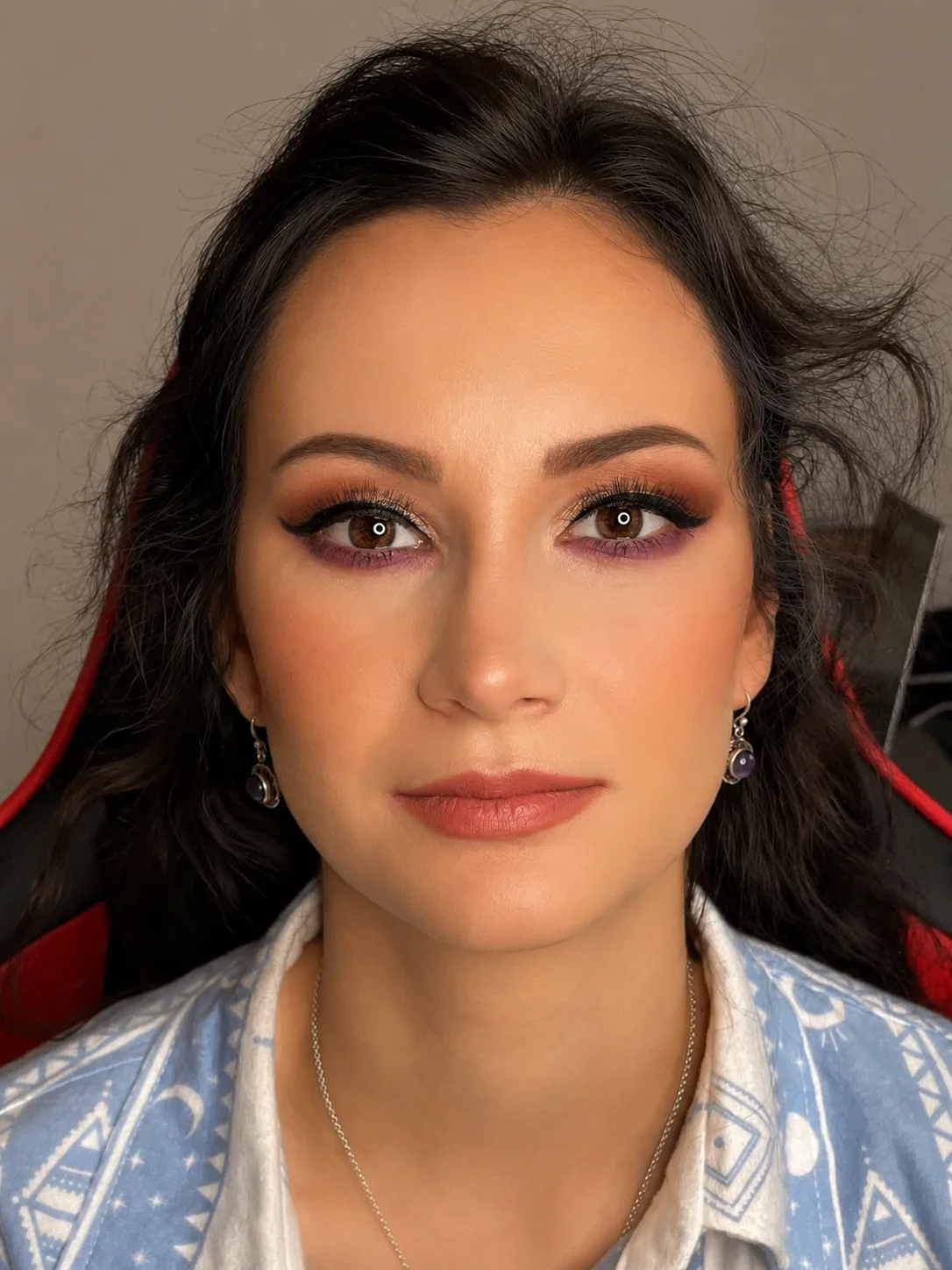 Party makeup - warm plum-purple smoky eye and nude peach-rose lip on dark-haired woman by MZ Makeup