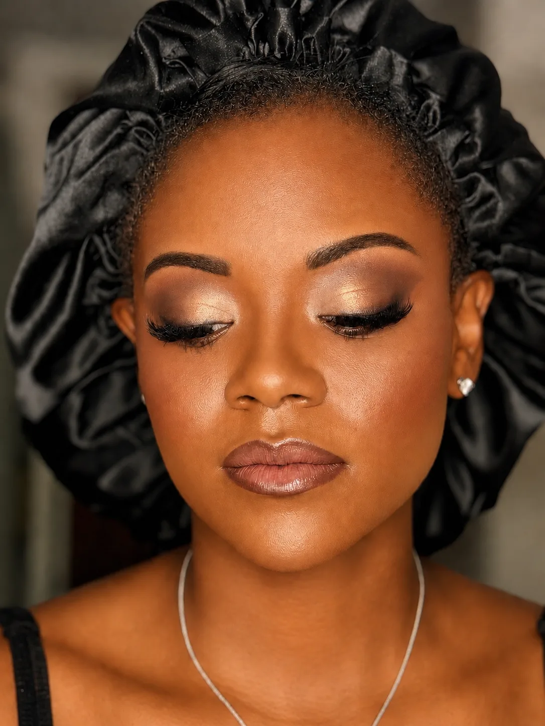 Bridal Makeup - MZ Makeup Bridal makeup eyes closed, deep/dark skin - warm copper-gold shimmer eye and soft nude-beige lip with satin bonnet by MZ Makeup