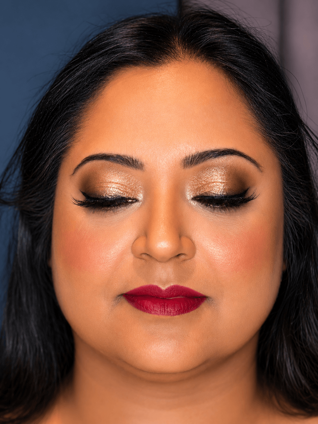 Bronze Shimmer Eye Party Makeup Close Up - MZ Makeup Bedfordshire Party makeup eyes closed, deep/dark skin - warm gold-bronze shimmer eye and deep berry-red lip by MZ Makeup