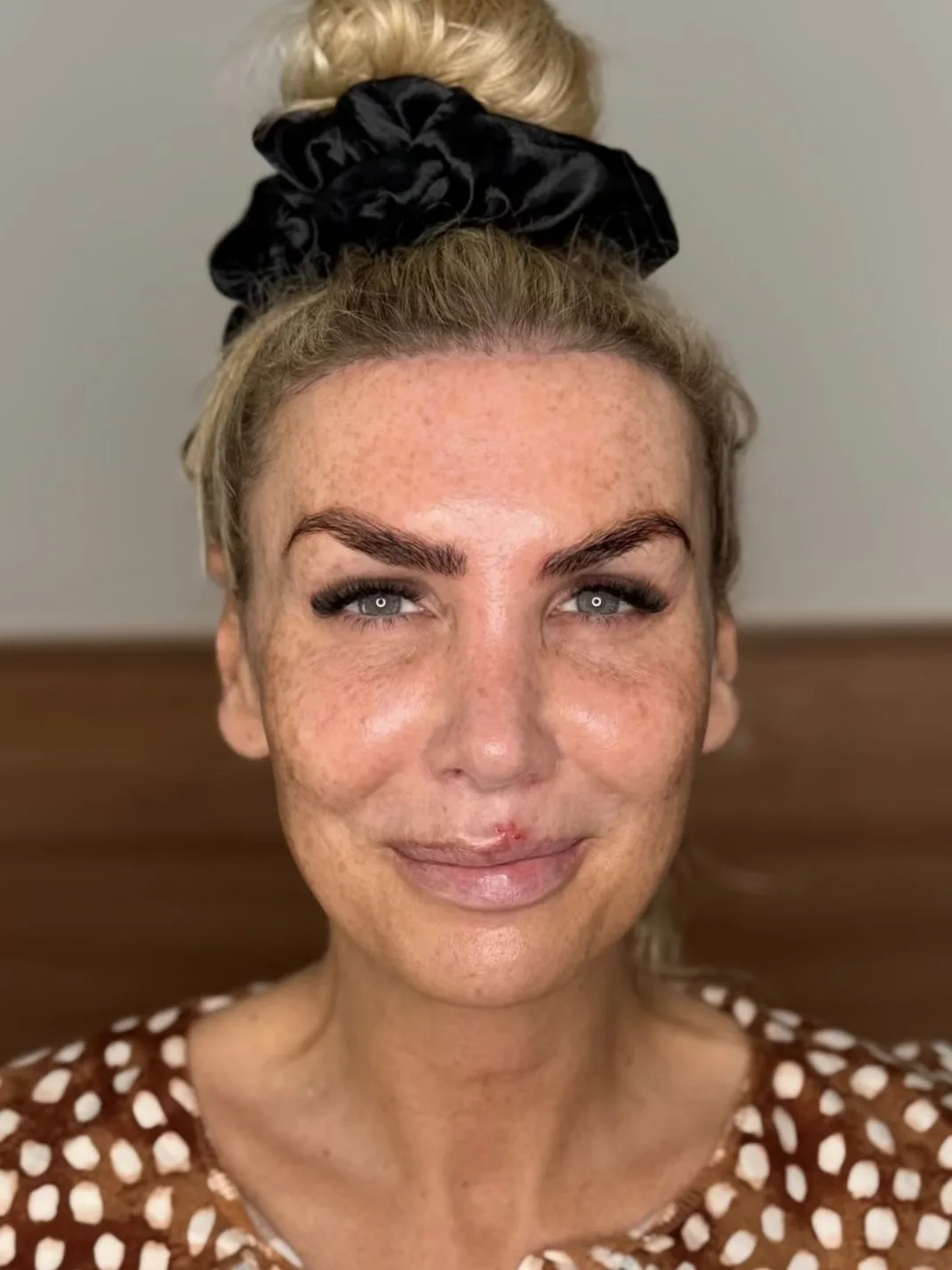 Before Smoky Charcoal Eye Party Makeup - MZ Makeup Bare skin before party makeup with blonde top bun, by MZ Makeup mobile makeup artist
